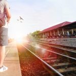 Traveller with backpack at train station